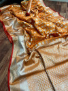 Orange color lichi silk saree with silver zari weaving work