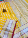 Yellow color lichi silk saree with zari weaving work