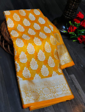 Yellow color organza silk saree with silver zari weaving butti