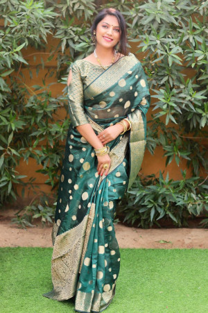 Dark green color organza silk saree with golden zari weaving work