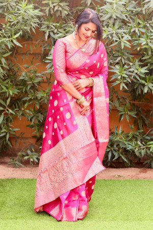Pink color organza silk saree with golden zari weaving work