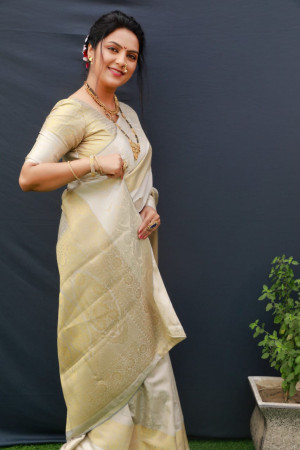 Off white color soft muslin silk saree with woven work