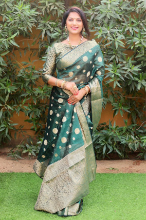 Dark green color organza silk saree with golden zari weaving work
