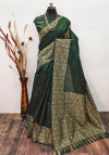 Dark green color raw silk saree with woven design