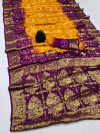 Mustard yellow and magenta color hand bandhej silk saree with zari weaving work