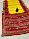 Yellow and maroon color bandhej silk saree with zari weaving work