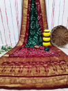 Green and maroon color bandhej silk saree with zari weaving work