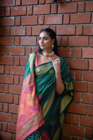Bottle green color soft raw silk saree with woven design