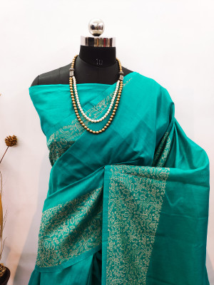 Sea green color raw silk saree with woven design