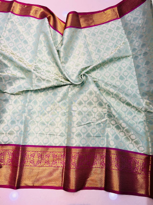 Sea green color tissue silk saree with woven design