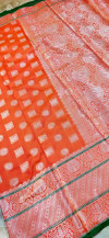 Orange color lichi silk saree with silver zari work