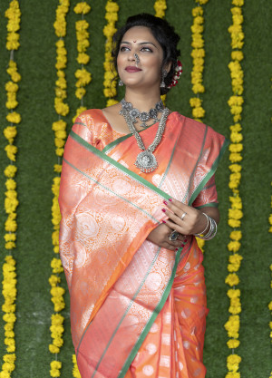 Orange color soft lichi silk saree with silver zari weaving work