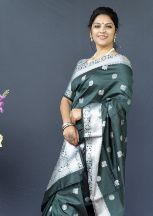 Dark green color soft lichi silk saree with silver zari woven work