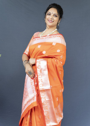 Orange color soft lichi silk saree with silver zari woven work