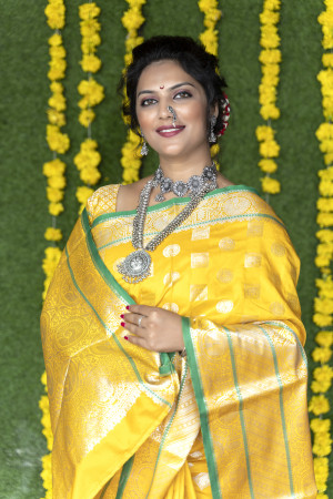 Yellow color soft lichi silk saree with silver zari weaving work