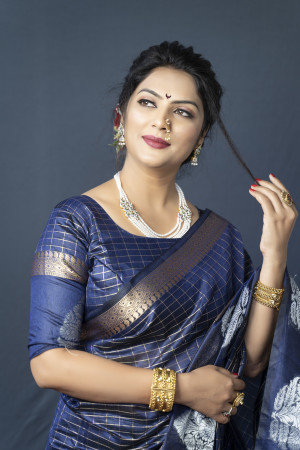 Navy blue color soft linen saree with golden and silver zari woven work