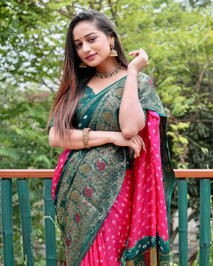 Rani pink and green color hand bandhej silk saree with zari weaving work