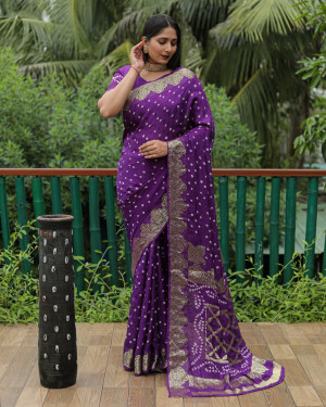 Purple color hand bandhej silk saree with zari weaving work