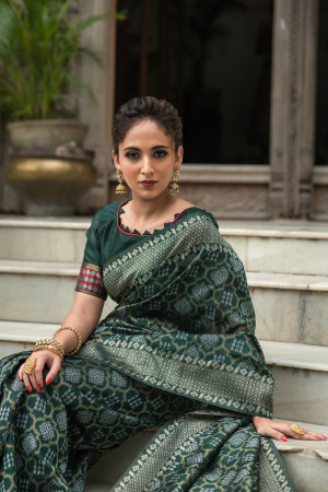 Dark green color tussar silk saree with woven design