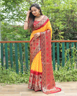 Yellow and red color hand bandhej silk saree with zari weaving work