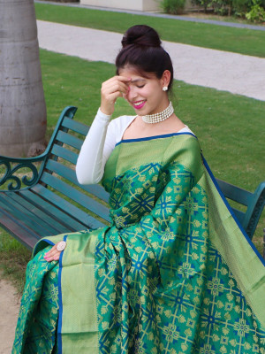 Green color patola silk saree with woven design