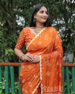 Orange color bandhej silk saree with printed work