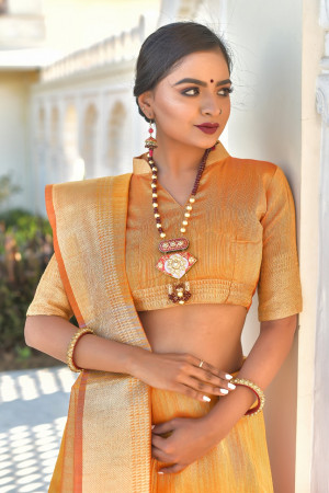 Orange color tassar silk saree with zari woven work
