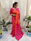 Orange and pink color bandhej silk saree with printed work