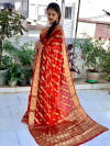 Orange and maroon color soft bandhej silk saree with zari weaving work