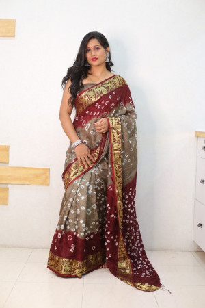 Beige and maroon color bandhej silk saree with zari weaving work