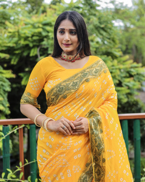 Yellow color pure hand bandhej silk saree with printed work