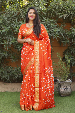 Orange color bandhej silk saree with zari weaving work