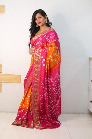 Orange and pink color bandhej silk saree with zari weaving work