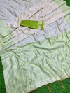 Off white and mahendi green color soft muga cotton saree with jamdani woven design