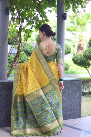 Yellow color tussar silk saree with patola weaving design