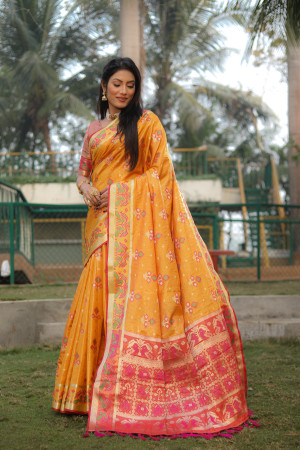 Yellow color soft organza silk saree with patola woven design