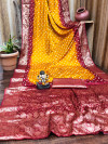 Orange and maroon bandhej silk saree with zari weaving work
