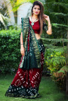 Red with green color hand bandhej bandhani saree with zari weaving border