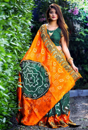 Dark green color hand bandhej bandhani saree with zari weaving border
