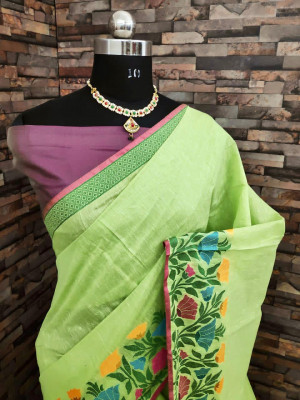 Pista green color linen silk saree with flowery weaving border