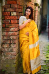 Mustard yellow color raw silk saree with woven design