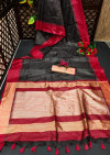 Black color tussar silk saree with zari woven contrast border