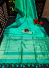 Sea green color tussar silk saree with zari woven contrast border