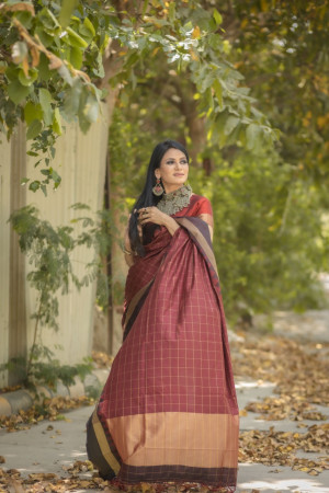 Maroon color soft raw silk saree with zari woven work