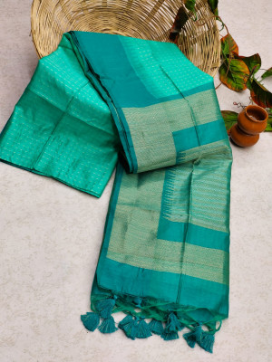Sea green color tussar silk saree with zari woven contrast border