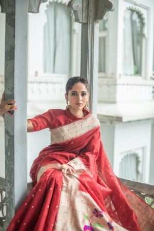 Red color paithani silk saree with zari woven border