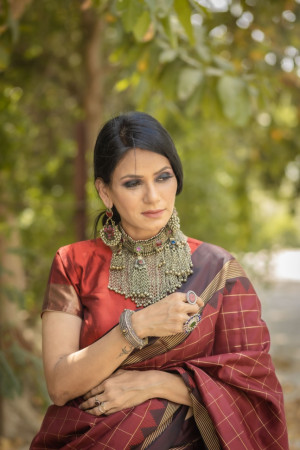 Maroon color soft raw silk saree with zari woven work