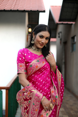 Rani pink color hand bandhej silk saree with zari weaving work