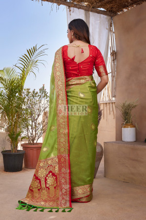 Green color organza silk saree with zari weaving work