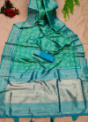 Sea green color patola silk saree with zari woven work